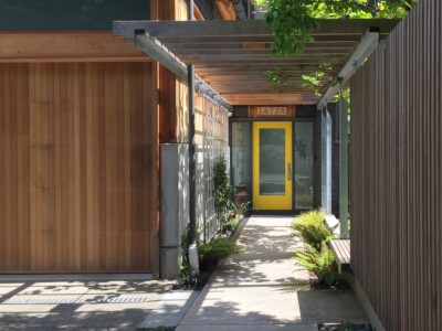 This naturalistic garden is experienced by the homeowners from a birdseye view as well as predominantly from a parallel edge along the entrance path, cedar bench and screen wall designed by ZeroPlus Architects, built by FarWest Construction.