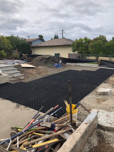One goal was to retain as much lawn area as possible and still have garage access. The new “driveway” area was laid with a product that would allow the lawn to be driven over without damaging the grass