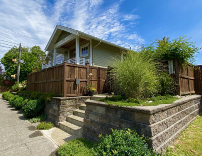 A welcoming and secure entry as well as additional garden space were created by repositioning a portion of the existing fence and installing new stable stairs and large scale concrete pavers A welcoming and secure entry as well as additional garden space were created by repositioning a portion of the existing fence and installing new stable stairs and large scale concrete pavers